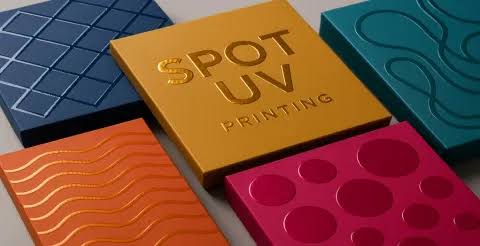 Spot UV printing samples with raised, high-gloss coating on coloured cards